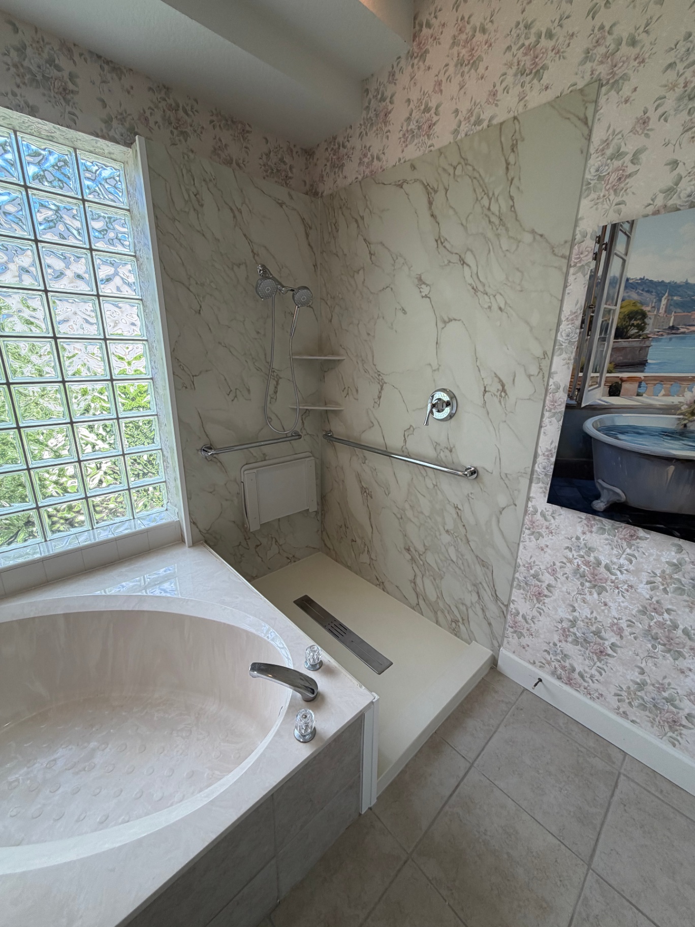 Soaker tub next to a marble-look walk-in shower